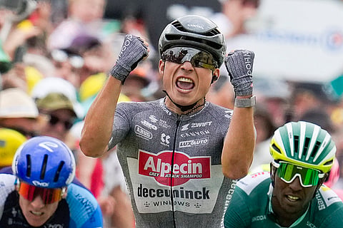 Belgium's Jasper Philipsen celebrates as he crosses the finish line